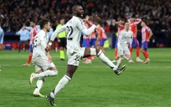 Antonio Rudiger (R) celebrates after scoring the penalty which took Real Madrid through to the Champions League quarter-finals at Atletico's expense
