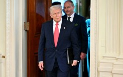 US President Donald Trump and Irish Prime Minister Micheal Martin (back) arrive for a St. Patrick's Day Reception in the White House