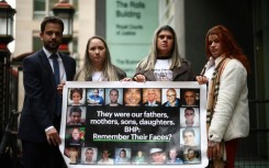 A banner outside the High Court in London showing victims of the mine disaster