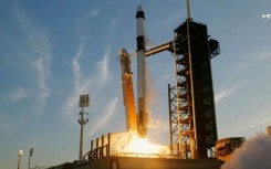 This screengrab image from NASA's live broadcast shows the SpaceX Falcon 9 rocket with the Crew Dragon capsule blasting off from the Kennedy Space Center in Florida bound for the International Space Station