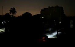 Car lights illuminate a street in Havana, Cuba during a widespread electricty blackout that hit much of the island nation