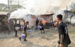 People trying to put out fires in Singu