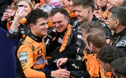 Lando Norris (left) celebrates with his McLaren team after winning the Australian Grand Prix