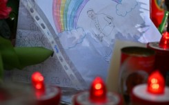 A drawing depicts Pope Francis under a rainbow outside the Gemelli hospital