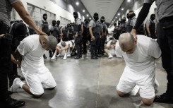 A handout picture released by El Salvador's Presidency press office shows alleged members of the Venezuelan criminal organization Tren de Aragua at the Terrorism Confinement Center