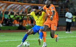 Gabon star Pierre-Emerick Aubameyang (L) fights for the ball during a 2026 World Cup qualifier against Ivory Coast.