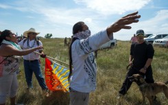 A Native American protestors holds up his arms as he and other protestors are threatened by private security guards and guard dogs, at a work site for the Dakota Access Pipeline (DAPL) oil pipeline, near Cannon Ball, North Dakota, September 3, 2016