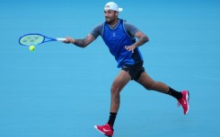 Nick Kyrgios returns a shot against Mackenzie McDonald en route to his first win since 2022