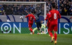 Japan's Daichi Kamada scores for the hosts