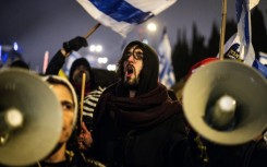 Protesters in Jerusalem demonstrate against Netanyahu's decision to oust the Shin Bet chief