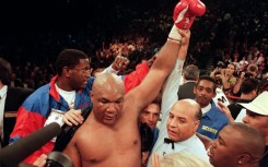 George Foreman raises his arm aloft after defeating Michael Moorer to recapture the heavyweight title in 1994