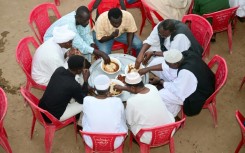 Sudanese, originally from the Darfur region, break their fast during a group iftar fast-breaking meal in the Muslim holy month of Ramadan, in Sudan's de-facto capital of Port Sudan