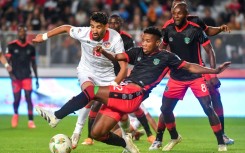 Tunisia forward Hazem Mastouri (L) is surrounded by Malawi defenders during a 2026 World Cup qualifier in Rades.