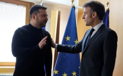 Ukraine's President Volodymyr Zelensky (L) says he speaks to France's President Emmanuel Macron (R) "once a day"