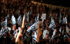 Israelis rally outside the parliament in Jerusalem on March 26, 2025, calling for an end to the war in Gaza, the return of all the hostages held by Hamas and against judicial reforms