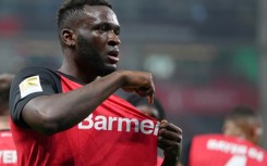 Bayer Leverkusen striker Victor Boniface points to the club's badge after scoring in Friday's 3-1 win over Bochum