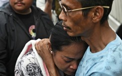 Naruemol Thonglek (C) is praying her boyfriend will emerge from the rubble where a Bangkok skyscraper collapsed in the wake of a devastating earthquake in Myanmar