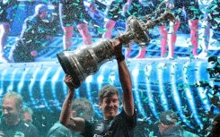 Team New Zealand's co-skipper and helmsman Peter Burling raises the America's Cup in Barcelona last year