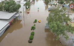Emergency crews work in flood waters as outback Australia drenched