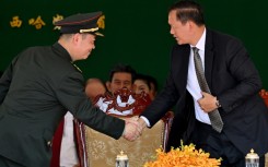 Cambodia's Prime Minister Hun Manet (R) shakes hands with Chinese general Cao Qingfeng (L) during an inauguration ceremony of the renovated Ream Naval Base in Preah Sihanouk province