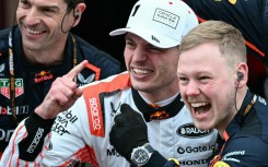 Max Verstappen (white cap) celebrates victory with his team members after the Japanese Grand Prix