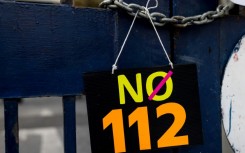 A sign is displayed outside the Criminal Court during a protest against article 112, Thailand's lese majeste royal defamation law