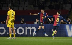 Barcelona's Polish forward Robert Lewandowski (C) celebrates scoring his team's second goal in the rout of Dortmund