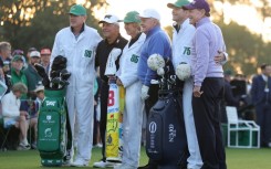 Honorary Starters Gary Player of South Africa and Americans Jack Nicklaus and Tom Watson of the United States pose with their caddies on the first tee after hitting honorary tee shots to start the 89th Masters