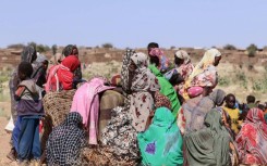 Displaced Sudanese women and children gather at a camp near the town of Tawila in North Darfur on February 11, 2025