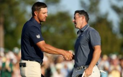 Rory McIlroy shakes hands with playing partner Bryson DeChambeau at the final hole of regulation at the Masters, where he triumphed in a playoff over Justin Rose