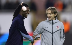 Real Madrid and Croatia midfielder Luka Modric (right) has bought a stake in Championship club Swansea