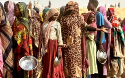 People who fled the Zamzam camp for the internally displaced after it fell under RSF control waiting for food rations at a makeshift encampment in western Darfur