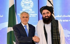 Pakistan Foreign Minister Ishaq Dar (L) with his Afghan counterpart Amir Khan Muttaqi during a visit to Kabul