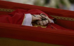 Pope Francis's body was placed in an open coffin before its removal to lie in state in the Vatican