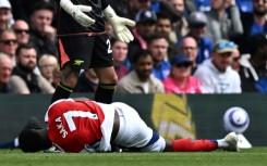 Arsenal's Bukayo Saka lies injured after Leif Davis's foul at Ipswich