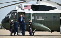 US President Donald Trump and First Lady Melania Trump step off Marine One upon arrival at Joint Base Andrews