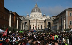People gather along Via della Conciliazione street ahead of late Pope Francis' funeral ceremony