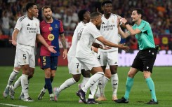 Real Madrid players remonstrate with Spanish referee Ricardo De Burgos Bengoetxea