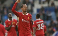Liverpool's Virgil van Dijk celebrates winning the Premier League title