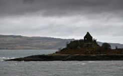 The Isle of Mull, pictured beyond a building in the foreground, across the Sound of Mull