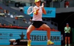 Iga Swiatek returns the ball during her Madrid Open quarter-final defeat of Madison Keys