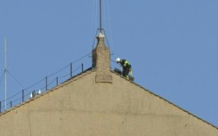 Vatican workers begin installing chimney atop Sistine Chapel for conclave