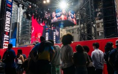 People gather around the outdoor boxing ring erected in Times Square for the fight card featuring Ryan Garcia's return from a doping suspension