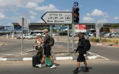 Travellers enter Israel's Ben Gurion airport after air defences were activated against a missile launched from Yemen