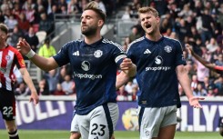 Manchester United's Luke Shaw (L) reacts after scoring an own goal against Brentford