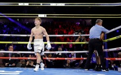 Undisputed super bantamweight champion Naoya Inoue of Japan, at left, walks away as referee Thomas Taylor stops the fight against American Ramon Cardenas in the eighth round