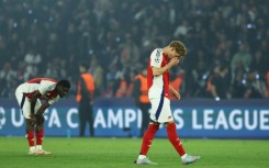 Arsenal's players react after their Champions League defeat against Paris Saint-Germain