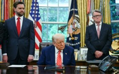 US President Donald Trump makes a trade announcement as US Vice President JD Vance (L), and British ambassador to the United States Peter Mandelson (R), look on in the Oval Office of the White House in Washington, DC, on May 8, 2025. US President Donald Trump on announced a "full and comprehensive" trade agreement with Britain, which would be the first such deal since he launched his global tariffs blitz.