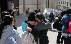 Palestinian schoolgirls leave a UNWRA school in the Shuafat refugee camp