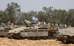 Israeli troops deploy at a position near the southern Israeli border with the Gaza Strip, on May 8, 2025
